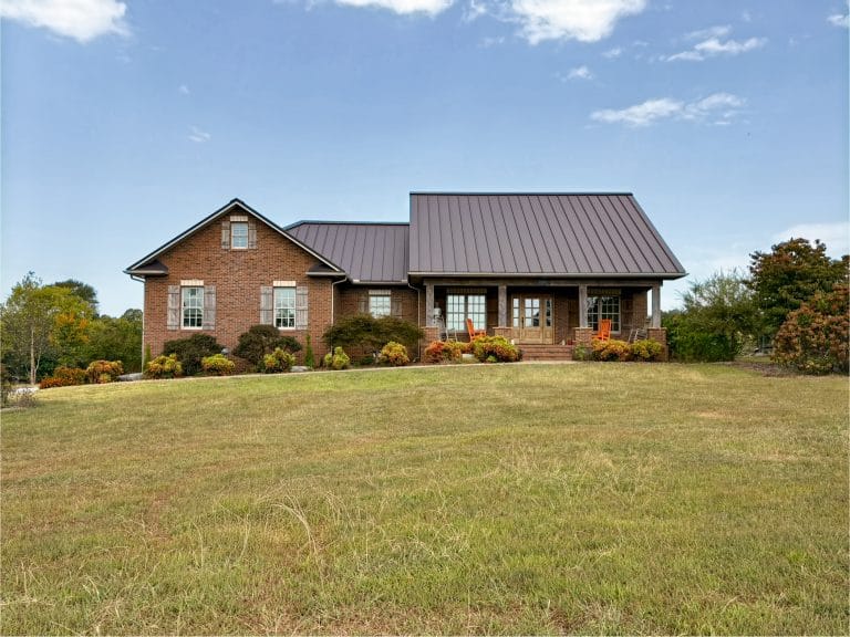 Front view of a beautiful home that has a newly installed standing seam roofing
