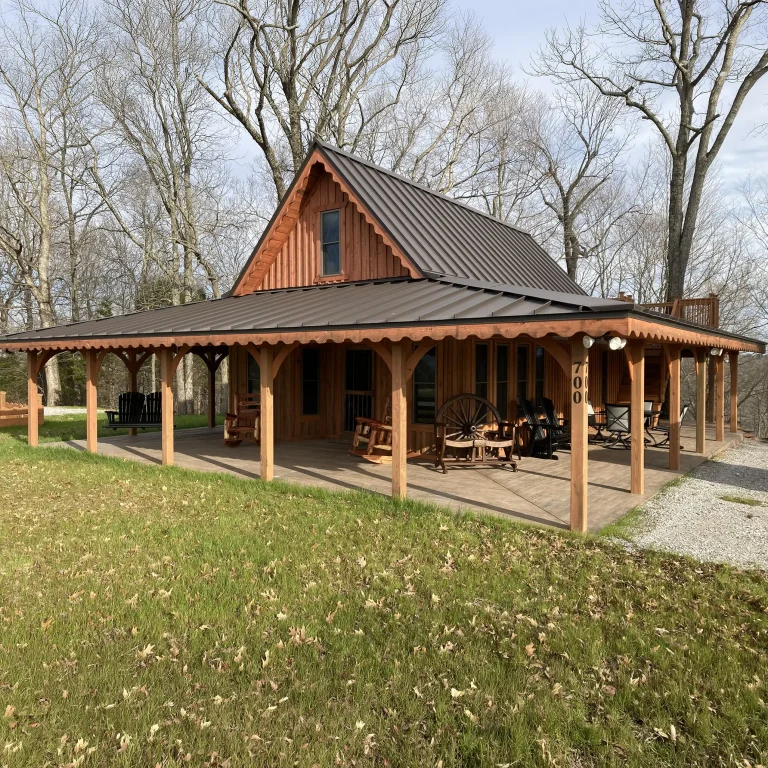 Cute summer cabin with wrap around porch and high quality standing seam metal roof. Learn more about Nate-O Roofing today