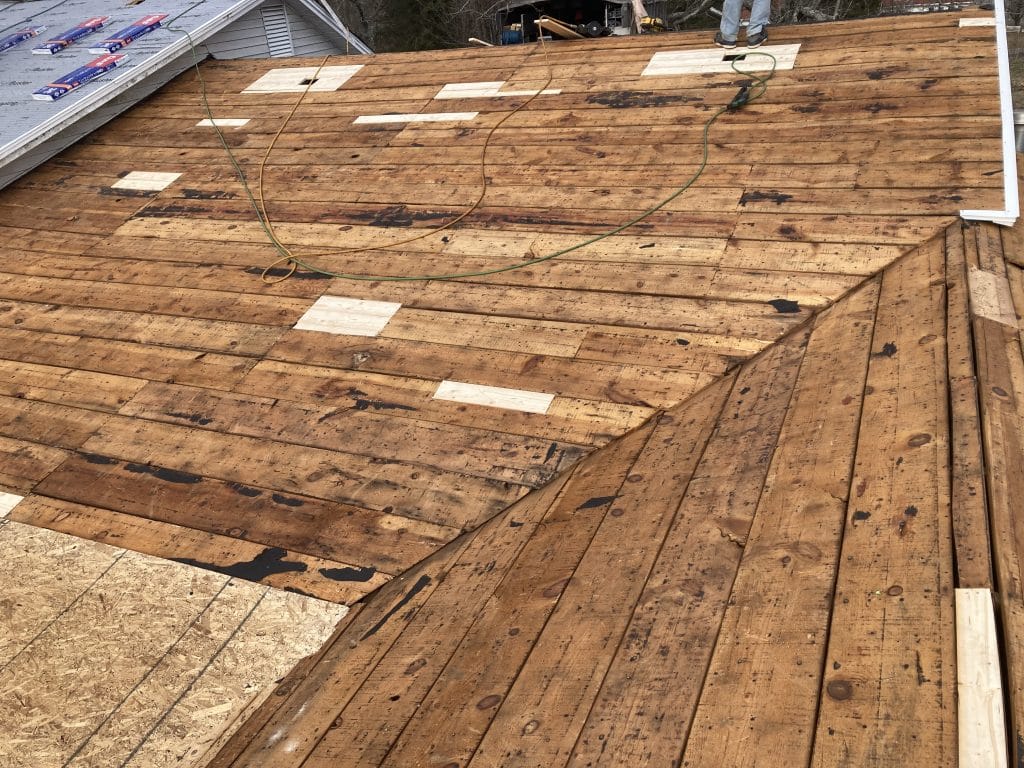 Old wooden slats that have been inspected and a few small sections repaired before replacing the roof.