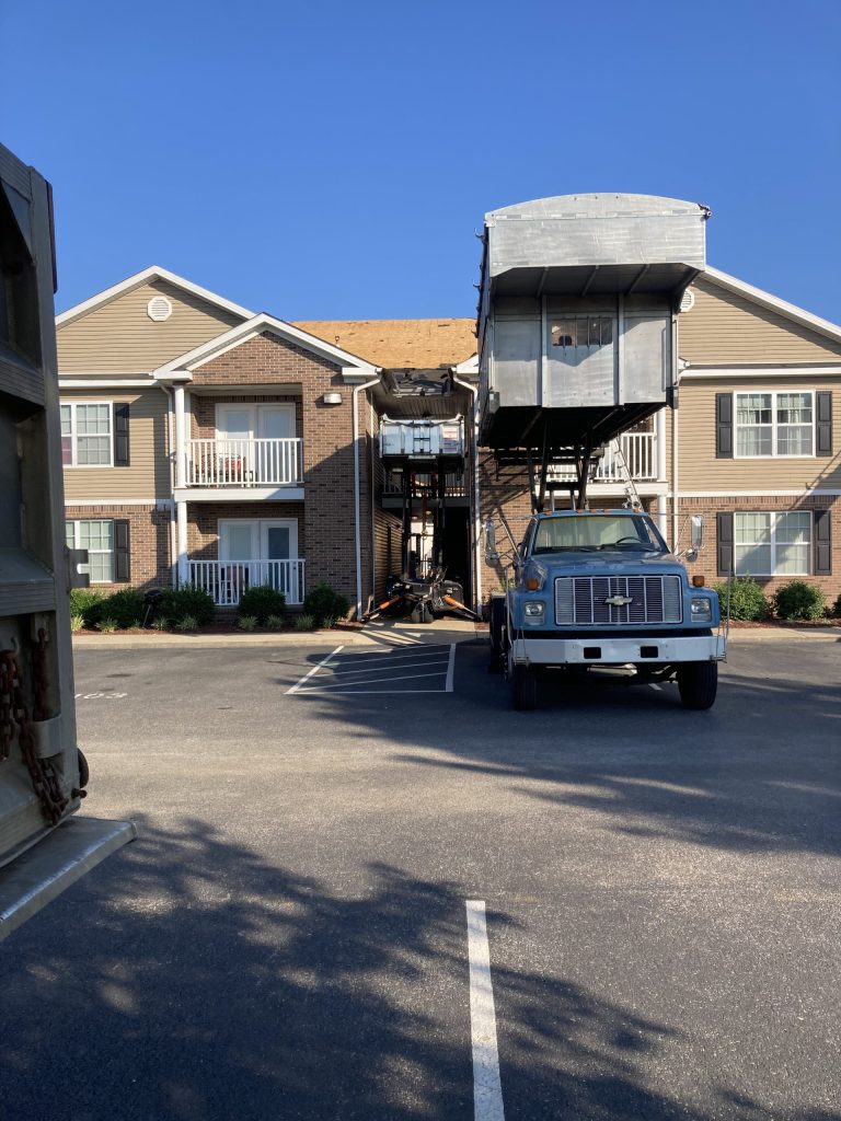 Specialized lift bed that helps minimize the amount of roofing debris that falls to the ground.