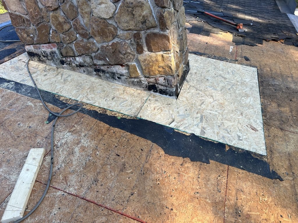 New OSB has been installed around this chimney where the old roof leaked, causing deterioration.