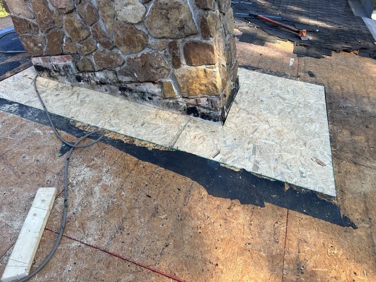 New OSB has been installed around this chimney where the old roof leaked, causing deterioration.